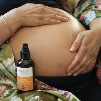 A pregnant woman using our Oh baby! Body Oil