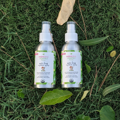 Two of our Bug Spray products on the green grass